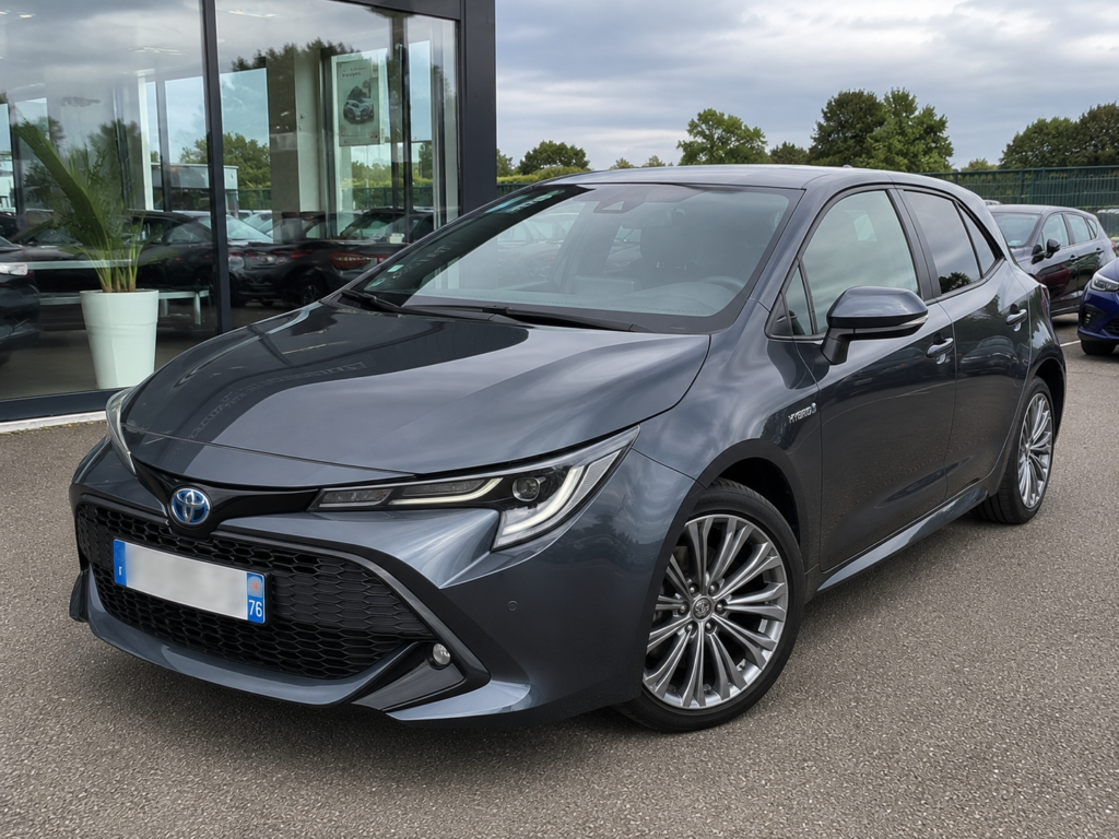 Toyota Corolla Hybride 2021 d'occasion à vendre, berline grise en excellent état avec plaque d'immatriculation floutée.